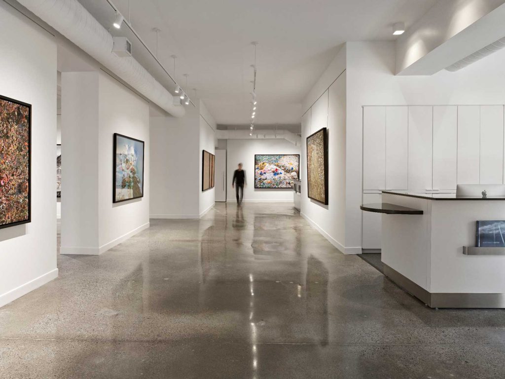 Vazt art gallery with white walls and polished concrete floor.