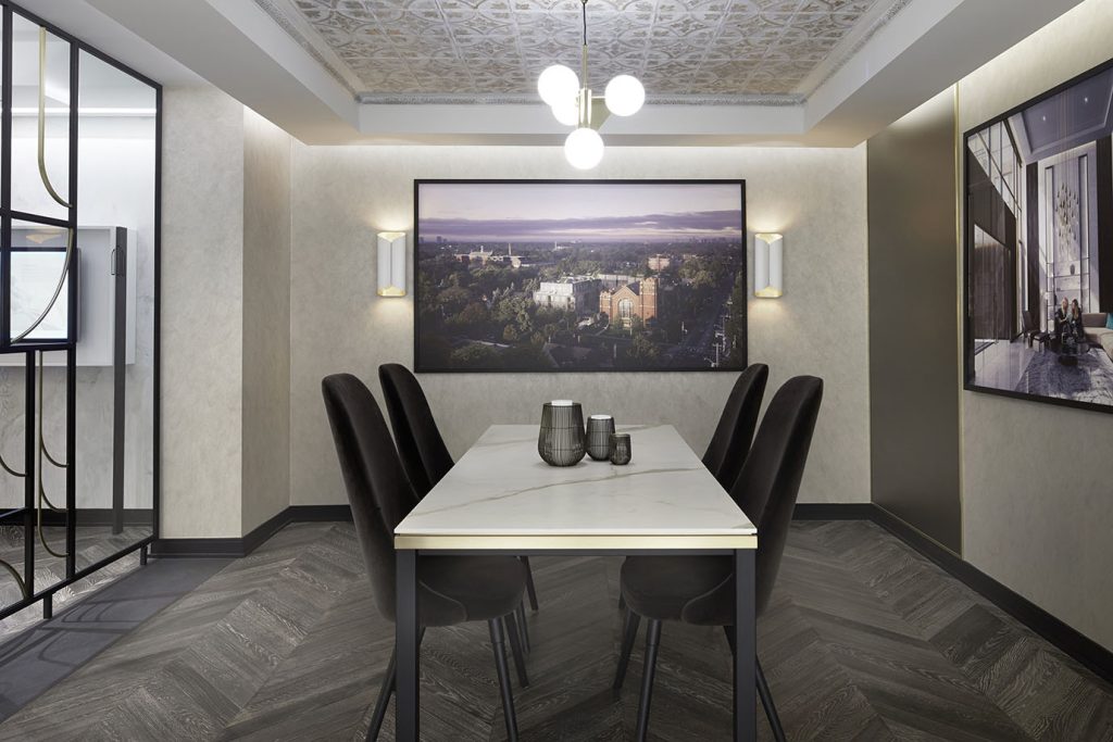 Closing office looks like a high end dining room setting, with large framed photos on the walls, beautiful light fixture