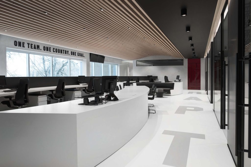 Custom ceiling framework of long slats running along the ceiling in this open concept office space