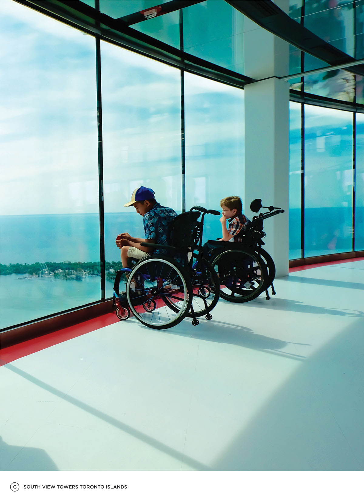 Two boys in wheel chairs looking onto the Toronto islands