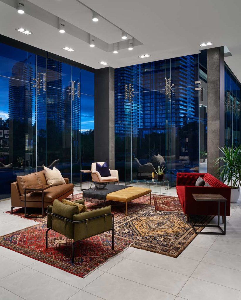 Colorful lounge area in the front lobby with eclectic mix of furniture and rugs reminiscent of Moroccan style décor.