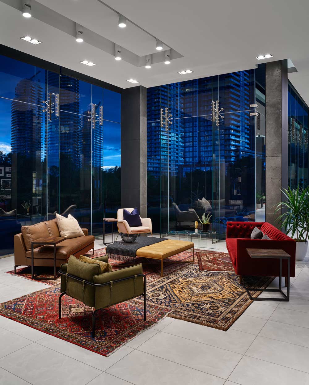 Colorful lounge area in the front lobby with eclectic mix of furniture and rugs reminiscent of Moroccan style décor.