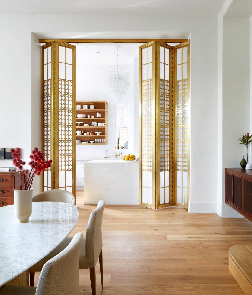 The 1930's inspired brass screen is half open, showing the intricate pattern detail