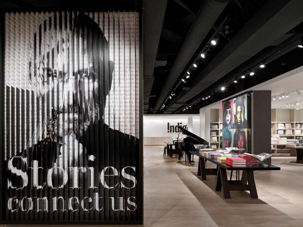 A more dramatic area of the store showcasing a black and white color scheme and some pops of color on shelving and posters throughout the space