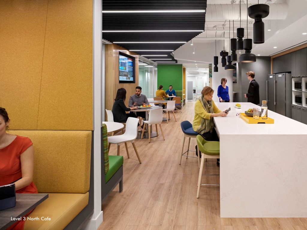 Another cafe area with colorful pops of green, yellow and blue, featuring plenty of seating and hang out spaces in booths, tables and bar tables