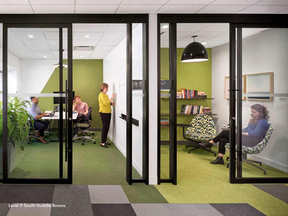 Two huddle rooms next to each other, offering space for collaboration
