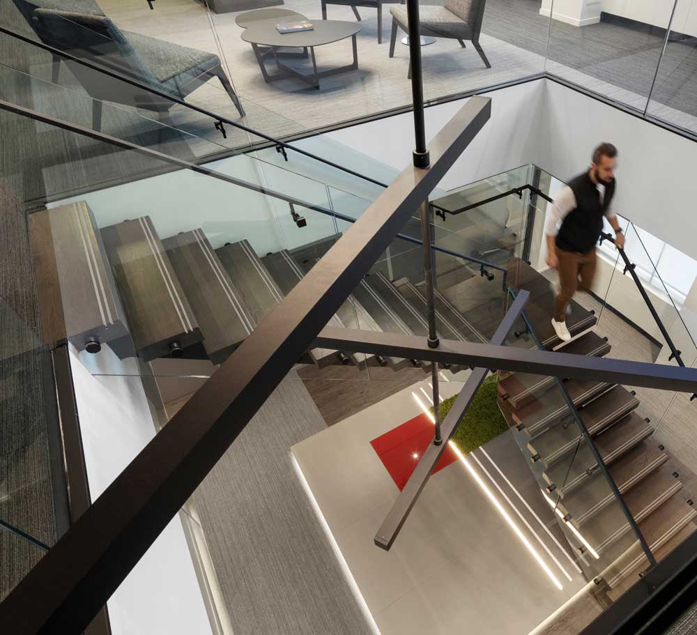 A view from the top floor at the staircase looking through the black sculpture hanging in the centre of the staircase