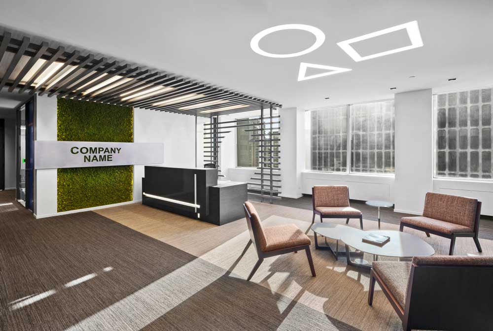 Light filled reception area with black slat sculptural detail running above the desk. Some biophilic details on the wall to accentuate the company name attached on top of it.
