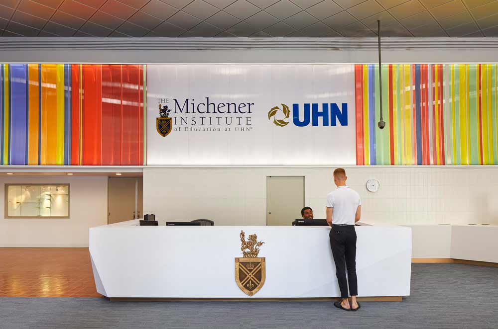 Close up of the new white front desk with the Institute crest.