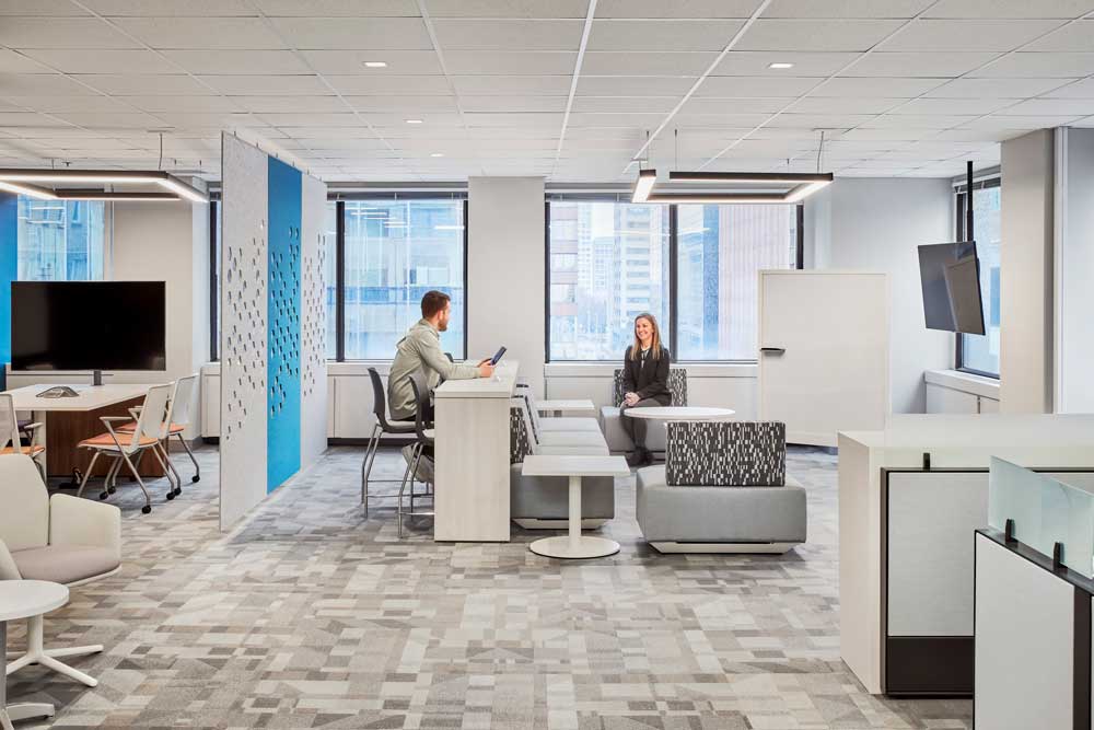 Open concept collaboration area surrounded by windows and views of the city