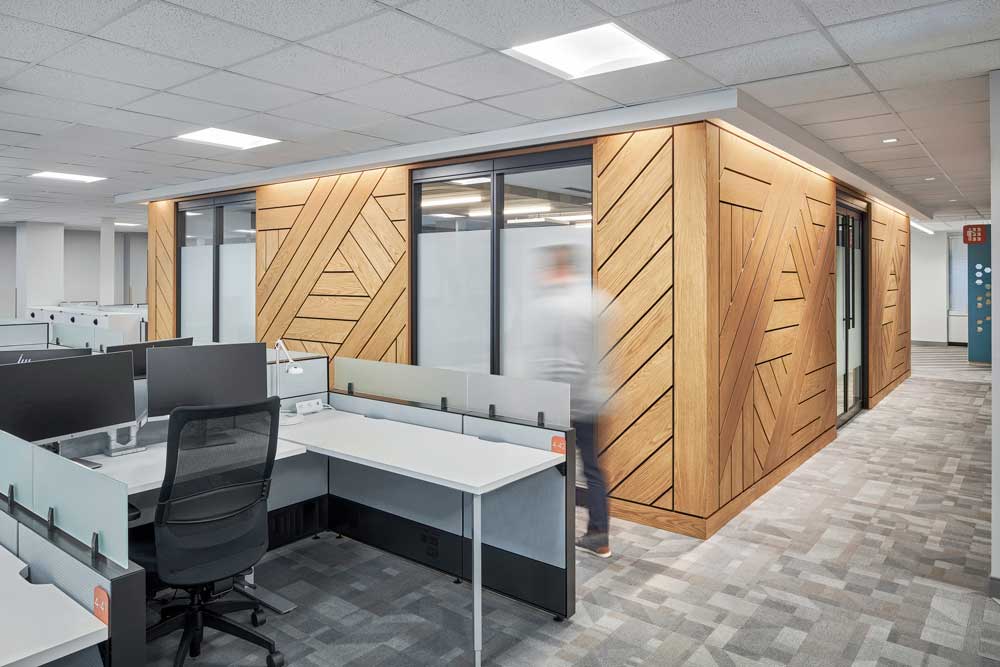 Workstation area and wood paneling wall feature with geometric diagonal line detailing