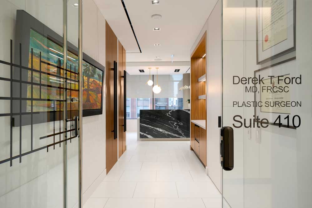 White walled hallway viewed from the main entrance glass door