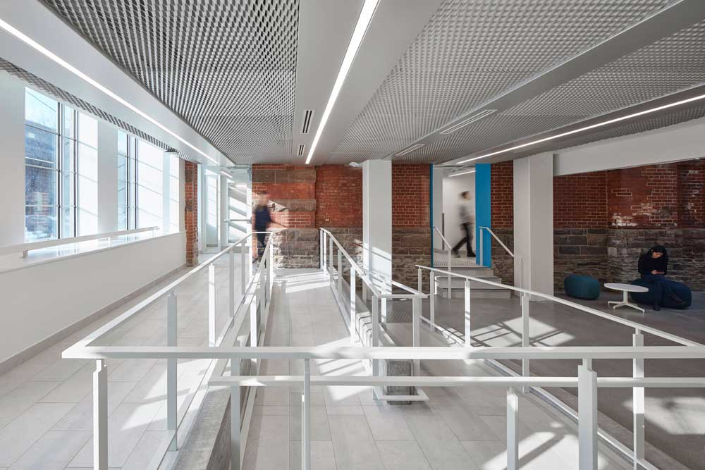 Mesh ceiling detail above the accessibility ramp at the entrance interior