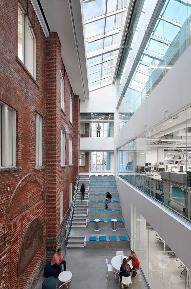 Contrast between the old brick building on the left and the new addition on the right. The common area atrium in the middle