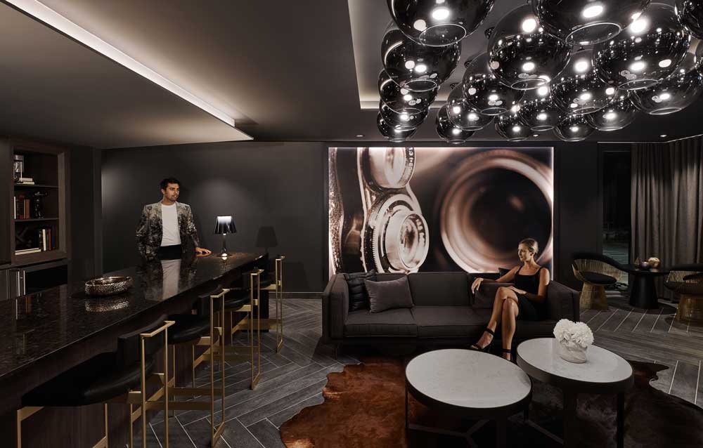 Luxurious bar and lounge area in Trafalgar Landing sales centre in dark luxe colour scheme and interior finishes