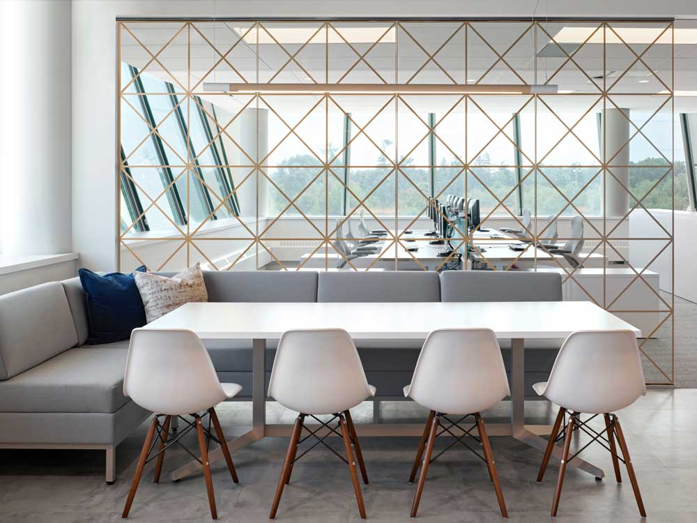 Kitchen lounge area separated from the work station area by a see-through wall with geometric pattern detail