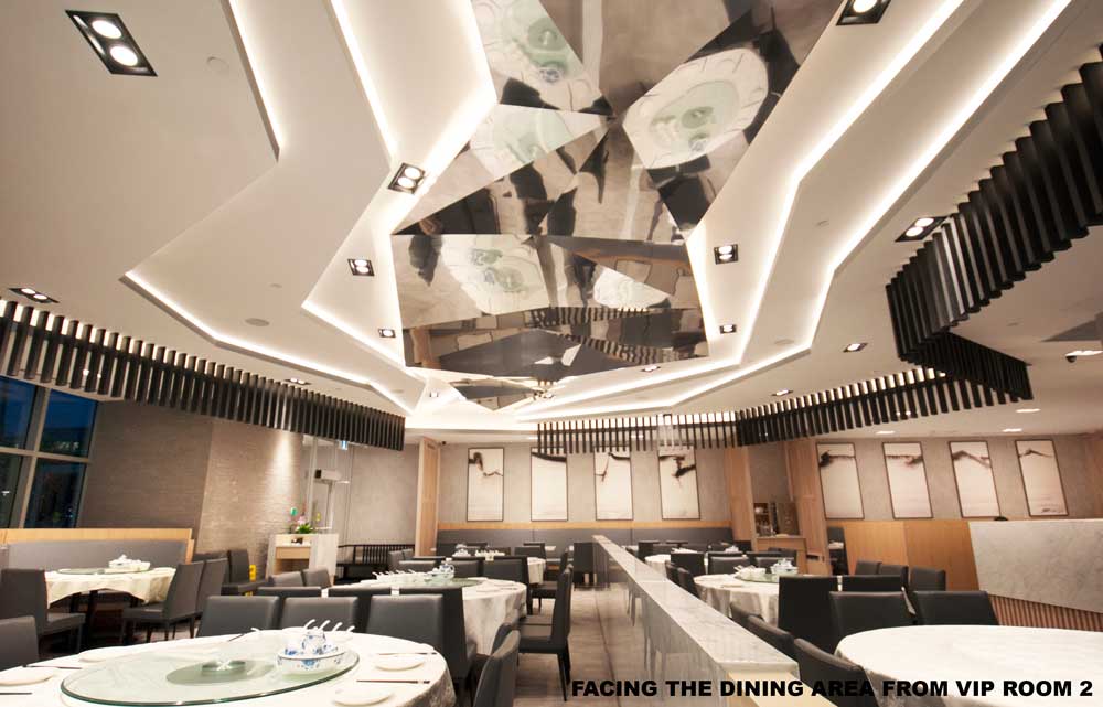 Reflective 'river' ceiling feature with small black vertical bars around the edge above the minimalistic, neutral coloured dining room