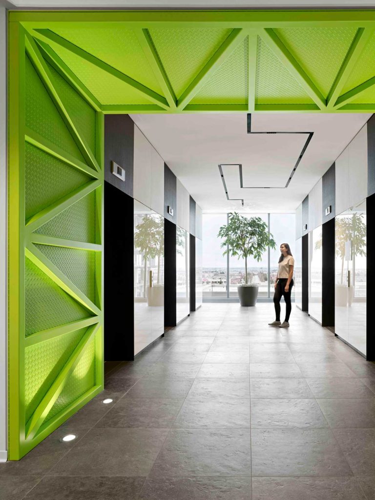 Elevator lobby with custom ceiling lights reminiscent of the Toronto laneway system