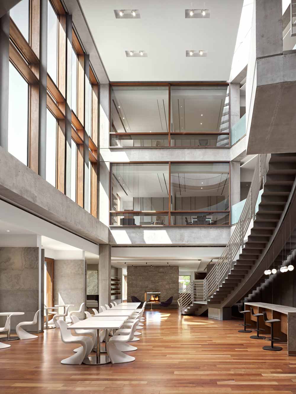 Atrium in the central area of the building with expansive common area on the ground floor and a stunning staircase leading to upper levels where the offices are