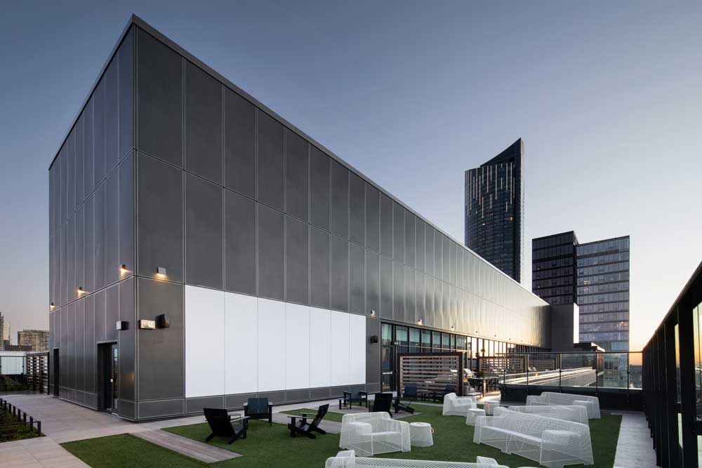 Outdoor rooftop area with lounge chairs