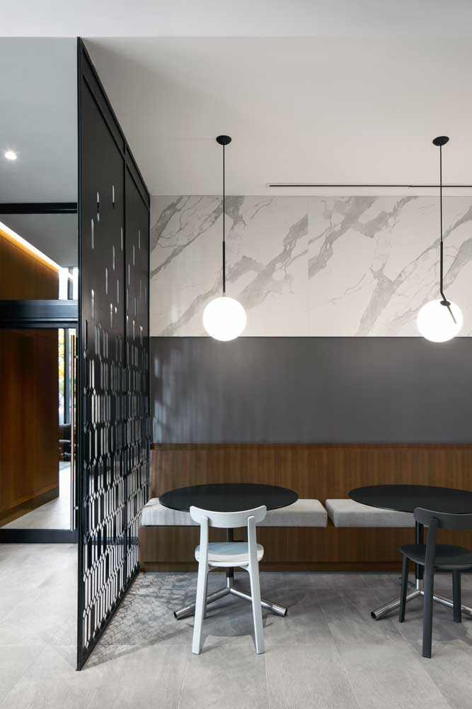 Vignette of the cafe separated from the lobby by a metal decorative screen