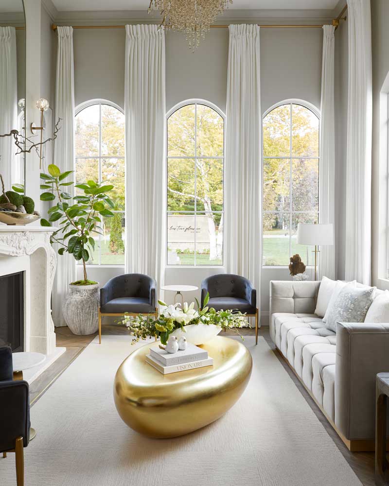 Bright lounge room featuring beautiful luxurious furniture and decor with the outdoors as the backdrop