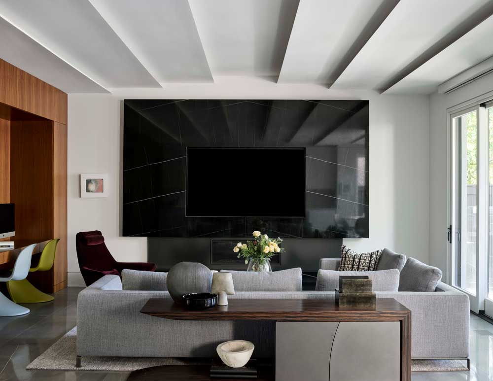 Living area that serves as a relaxing family time spot, homework area with a few fun pops of colour