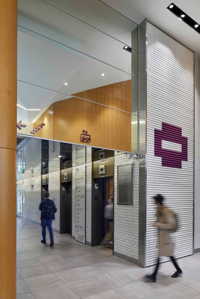 Elevator lobby entrance showing the mirrors on the ceiling that make the whole space seem to have double height like the rest of the lobby space
