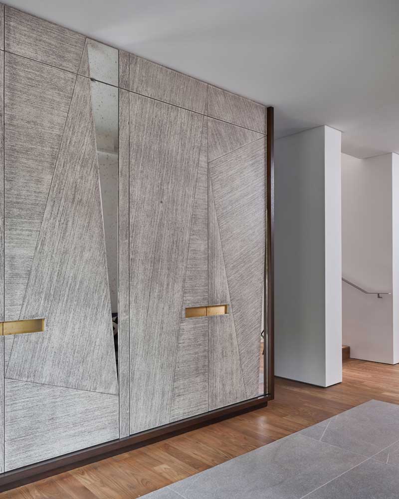 doors made of raised grain mahogany with a textured wash stain and antique mirror