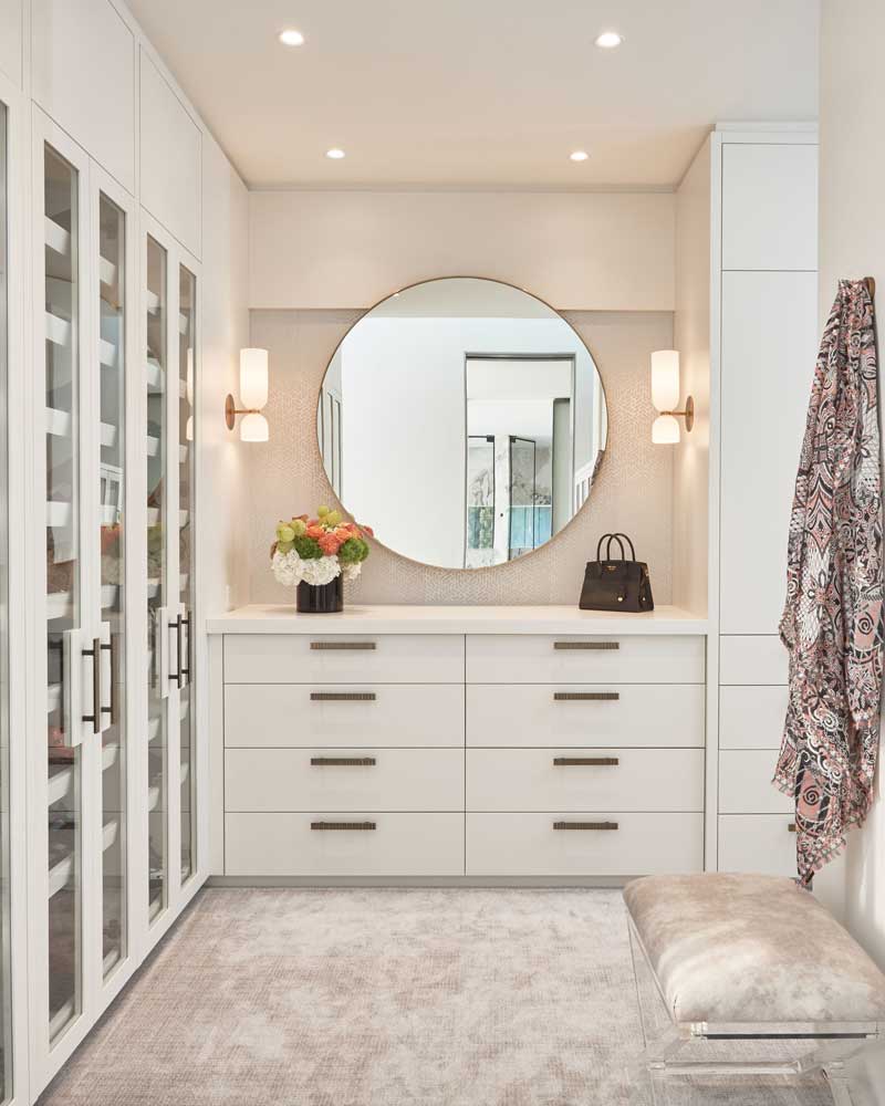 Large walk in closet with floor to ceiling built in cabinetry