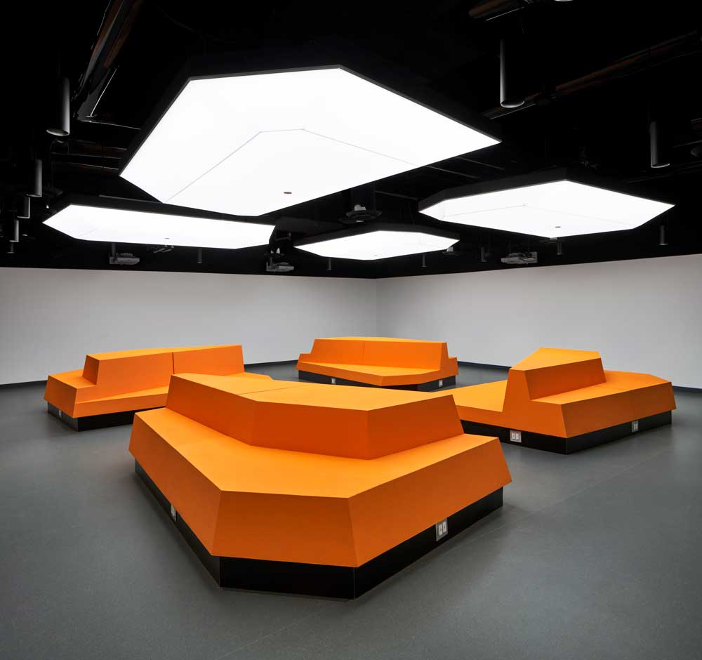 Another view of the main classroom, or lecture hall and the geometric LED lighting above