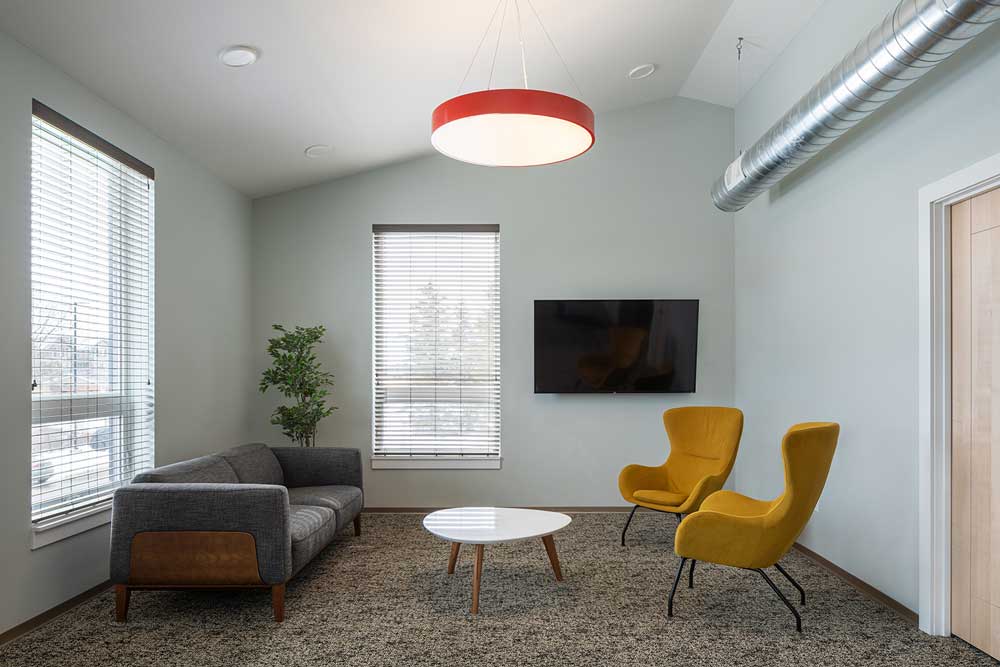 A room for gathering and socializing with comfortable sofa and warm yellow lounge chairs