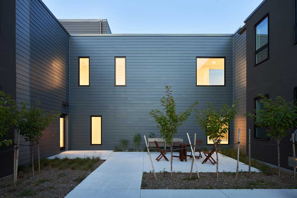 A small courtyard with seating in between the building units