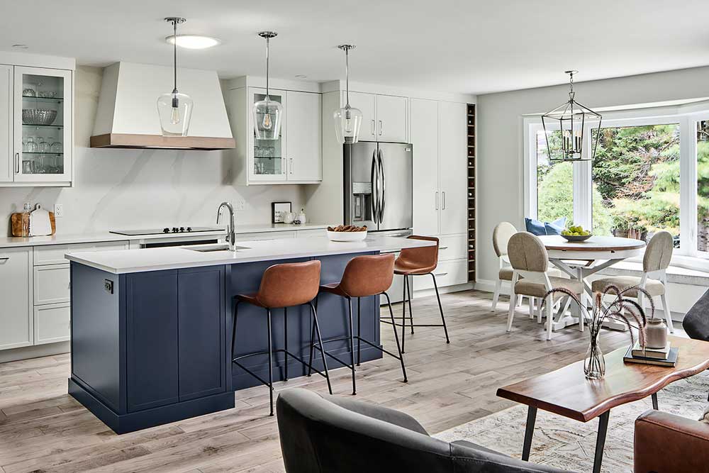 Kitchen and dining area with a lounge space visible, all in modern farmhouse style with touches of dark blue and brown