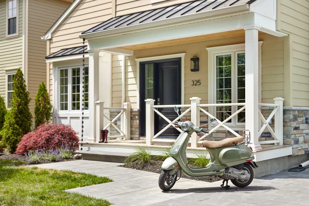 Charming Niagara-On-The-Lake style exterior of the home, and a Vespa parked in front
