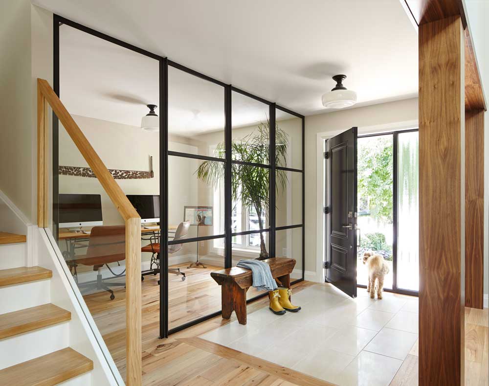 Spacious modern Foyer separated from the office space by a glass wall with modern black detailing