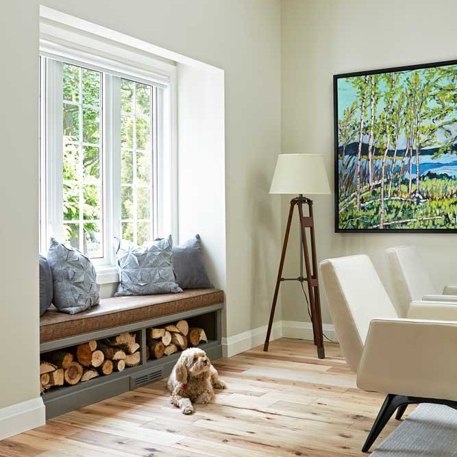 The dog enjoys a nice, warm spot by the living room bay window with seating
