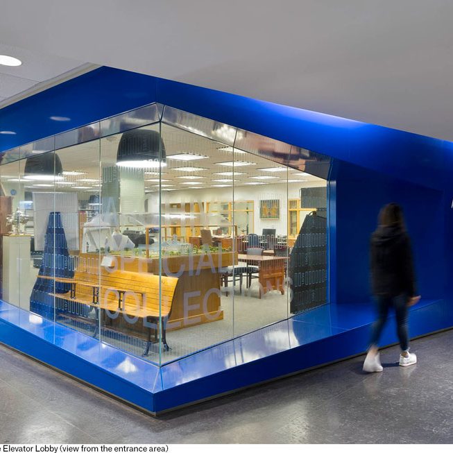 Shiny blue corner wall with glassed corner window showing Ryerson University Archives and Special Collections.