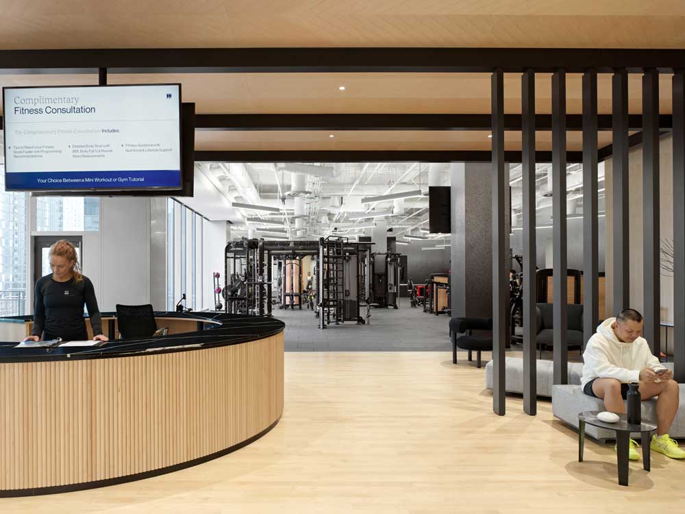 Entry pavilion clad in a fluted wood accent, refreshment bar, and lounge area.