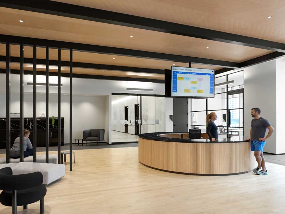 Entry pavilion clad in a fluted wood accent, refreshment bar, and lounge area.