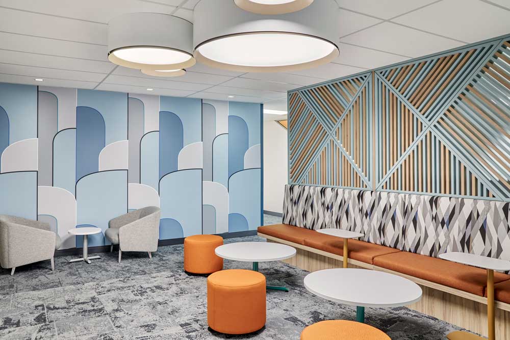 Lounge area with blue graphic wall detail and added accent with orange details like furniture