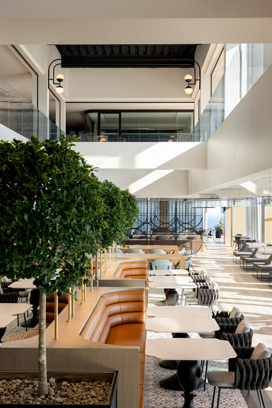 3 story atrium in BCG Canadian headquarters, with greenery and comfortable seating areas