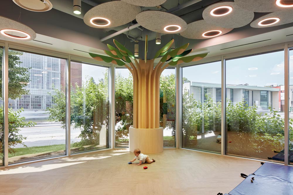 Stylized tree in the middle of the main motor skills room in the day care