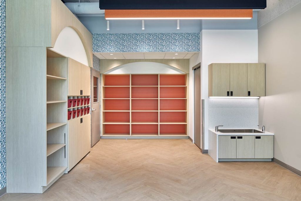 Lots of shelving and storage and small sinks and fun accent colours on the back of the shelves and on the ceiling and bulkheads