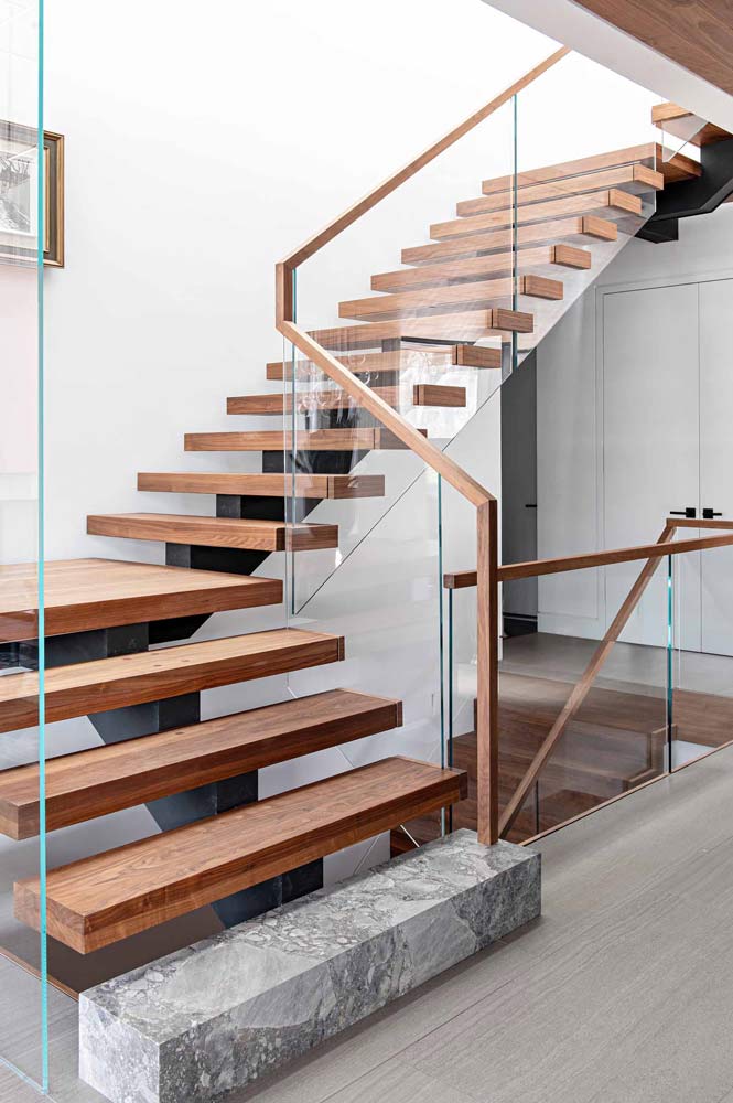 Modern wooden staircase, glass railings with thin wooden framing