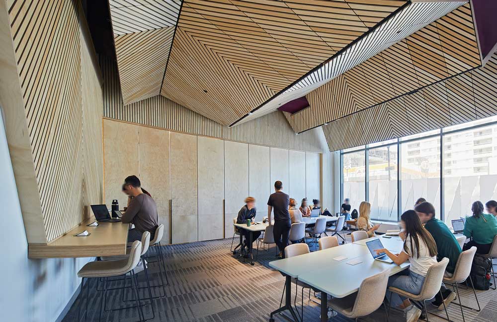 A study room in the library with wooden patterned ceiling panel detail 