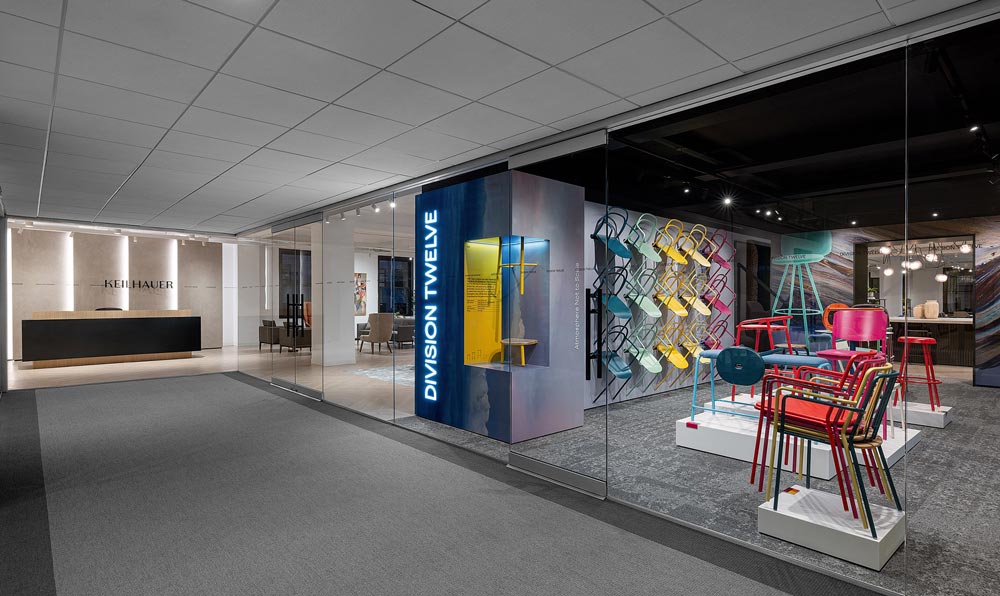 Colourful chairs and furniture are on display through the large window by the main entrance to the showroom leading to the reception desk