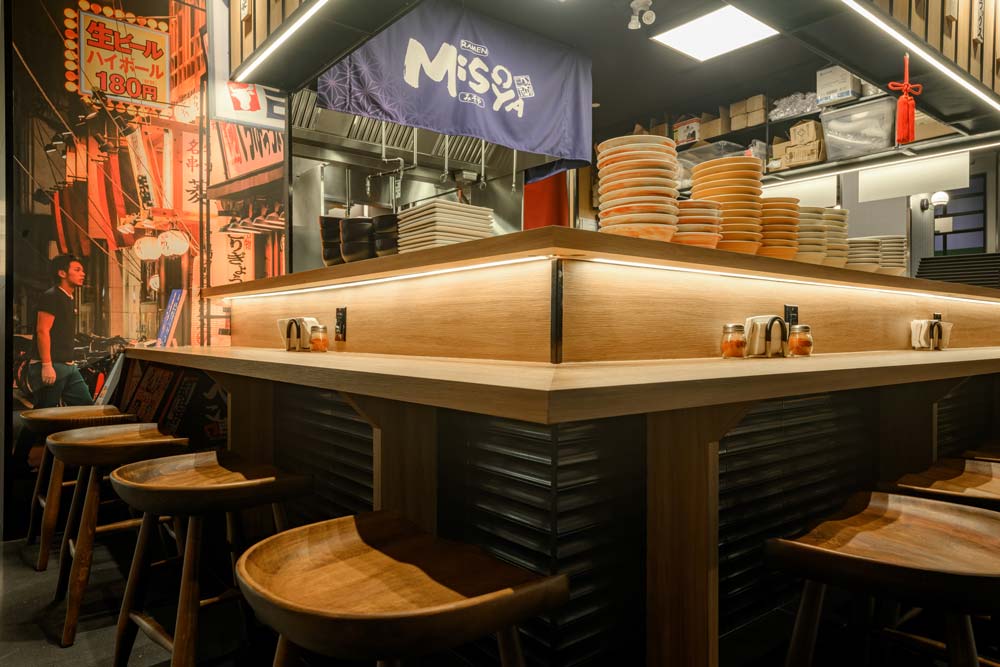 The design of the dining counter considers accessibility requirements, ensuring all patrons can enjoy the ramen experience without feeling excluded or singled out